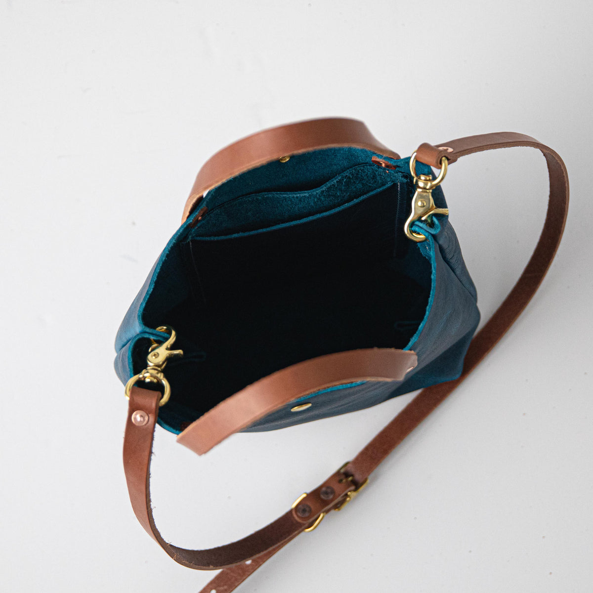 Petrol Blue Bison Mini Tote: vibrant blue full-grain leather bag with tan handles and gold hardware.