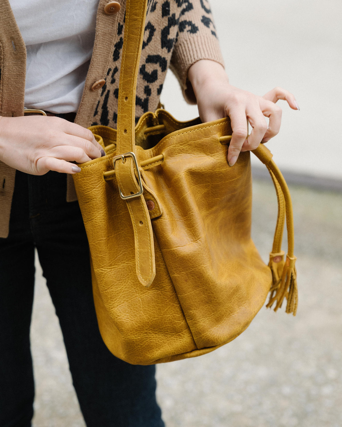 Yellow Bison Bucket Bag, handmade full-grain leather, vibrant yellow hue, prominent grain, soft temper, drawstring closure.