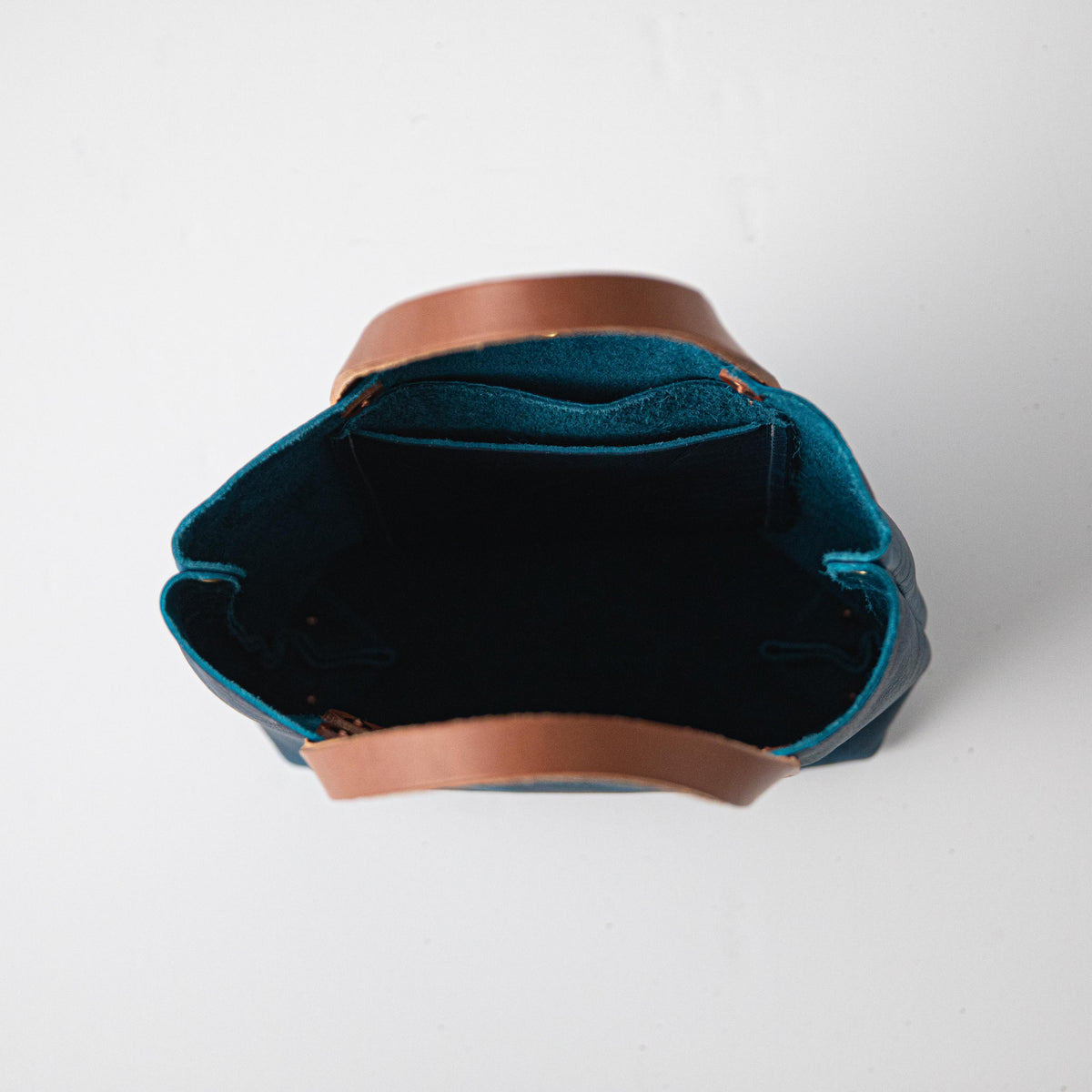 Petrol Blue Bison Mini Tote: handmade full-grain leather bag with vibrant blue exterior, tan handles, and open top.