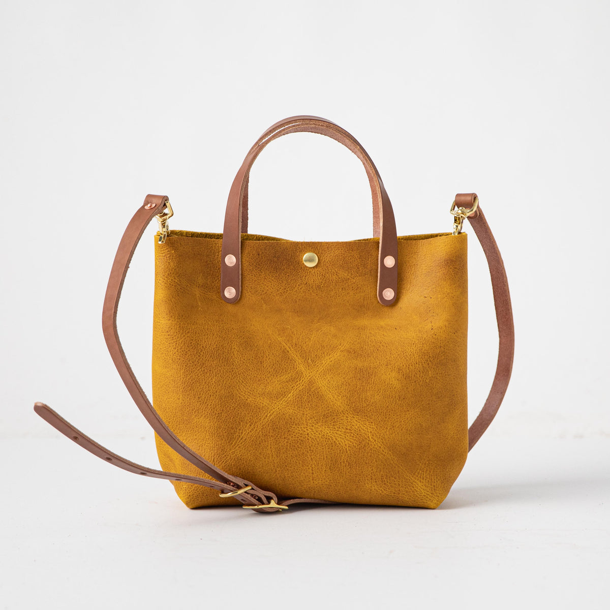 Vibrant Yellow Bison full-grain leather mini tote with tan handles and a detachable shoulder strap.
