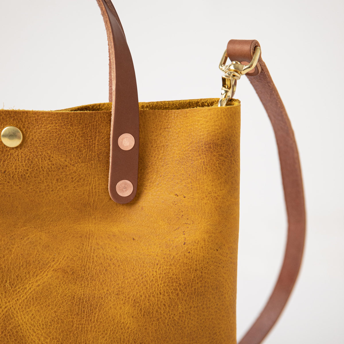 Yellow Bison Mini Tote: vibrant full-grain leather, tan handles, and brass hardware.