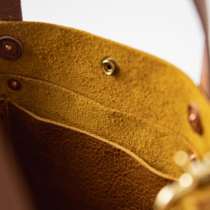 Yellow Bison Mini Tote interior, showcasing vibrant full-grain leather, soft temper, and sturdy brass hardware.