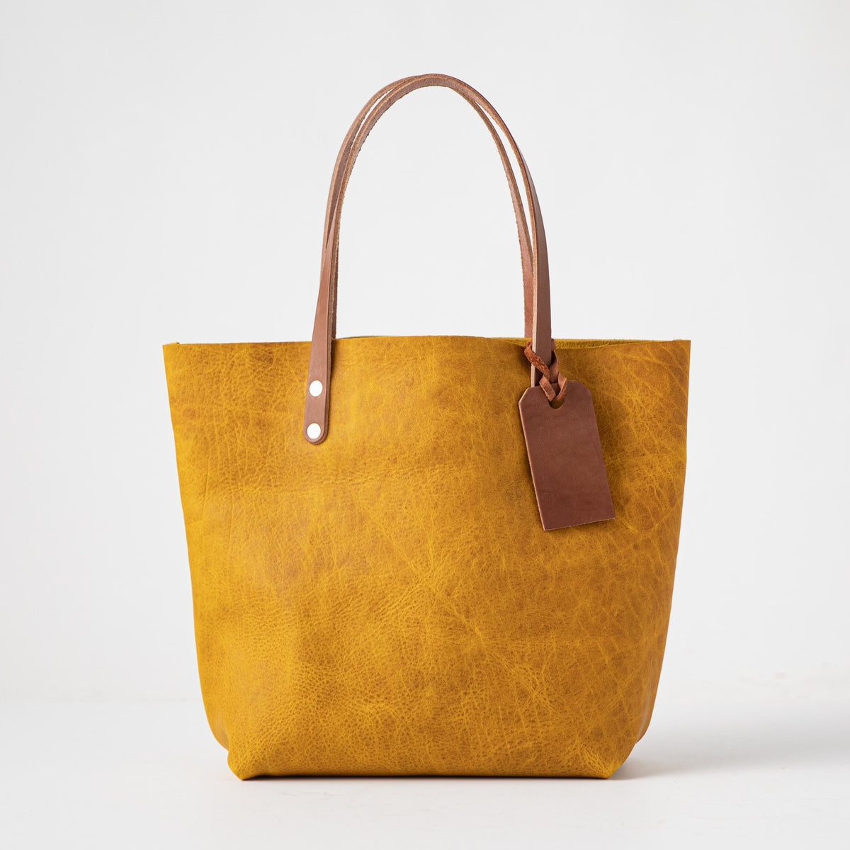 Vibrant Yellow Bison leather tote bag with Tan handles and a brown leather tag.