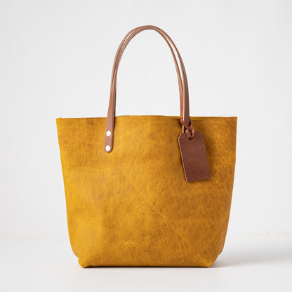 Vibrant Yellow Bison leather tote bag with Tan handles and a brown leather tag.