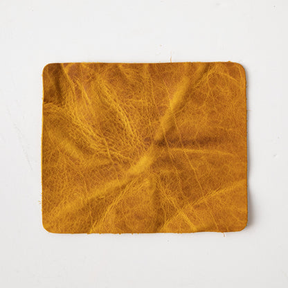 Close-up of a square Yellow Bison leather swatch, showcasing its vibrant yellow hue, prominent grain, and soft temper.