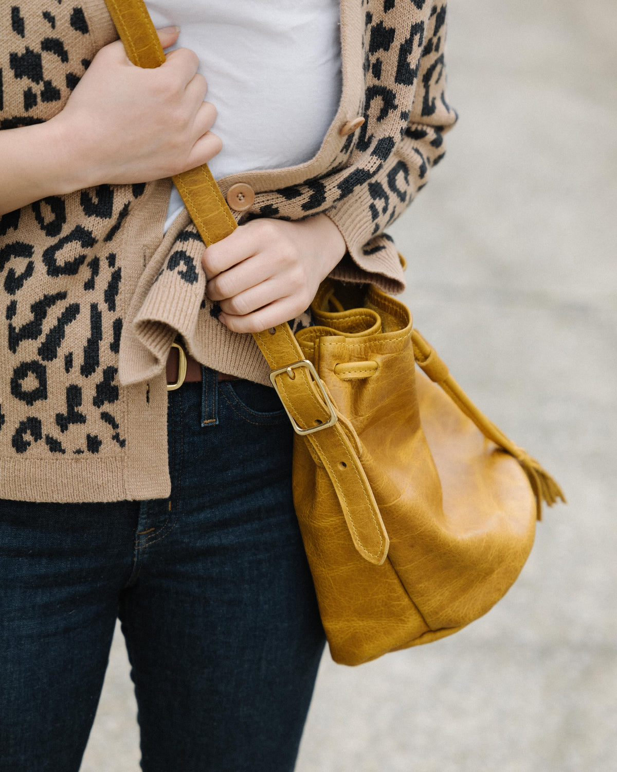 Yellow Bison full-grain leather bucket bag with prominent grain, soft temper, and adjustable strap.